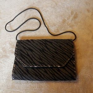 Vintage clutch purse with shoulder strap.